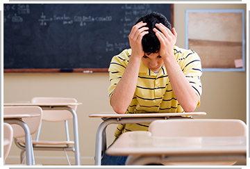 student alone in classroom, unable to study
