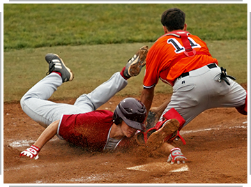 baseball player tagging other player sliding into home base