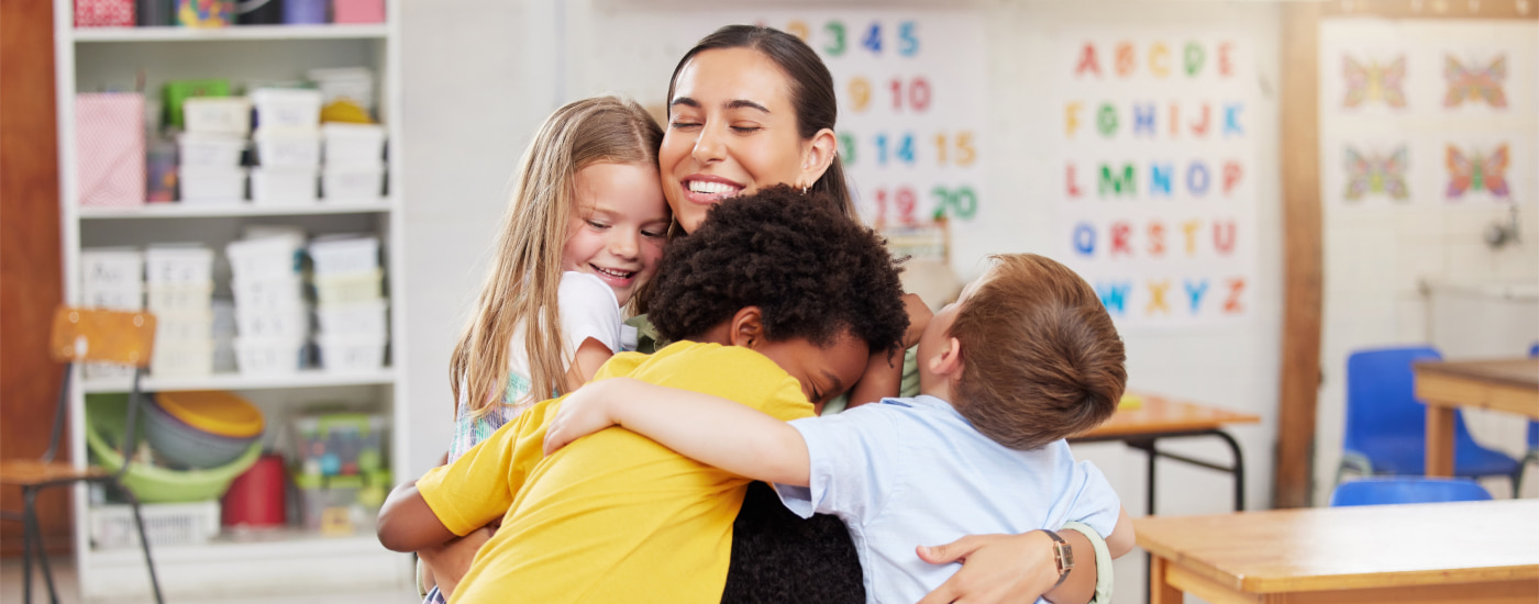 Teacher hugging kids