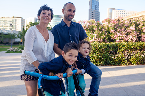 Family in the city park, child with cerebral palsy