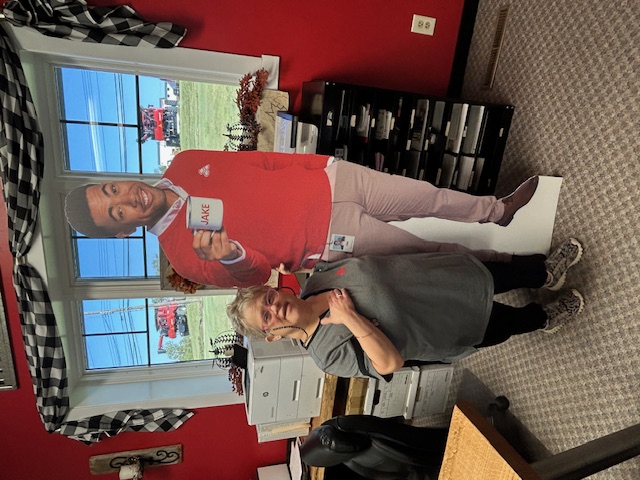 Giving a thumbs up with a cardboard cutout of the State Farm mascot