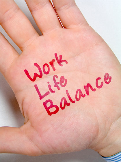 A hand with the words "Work Life Balance" written on the palm.